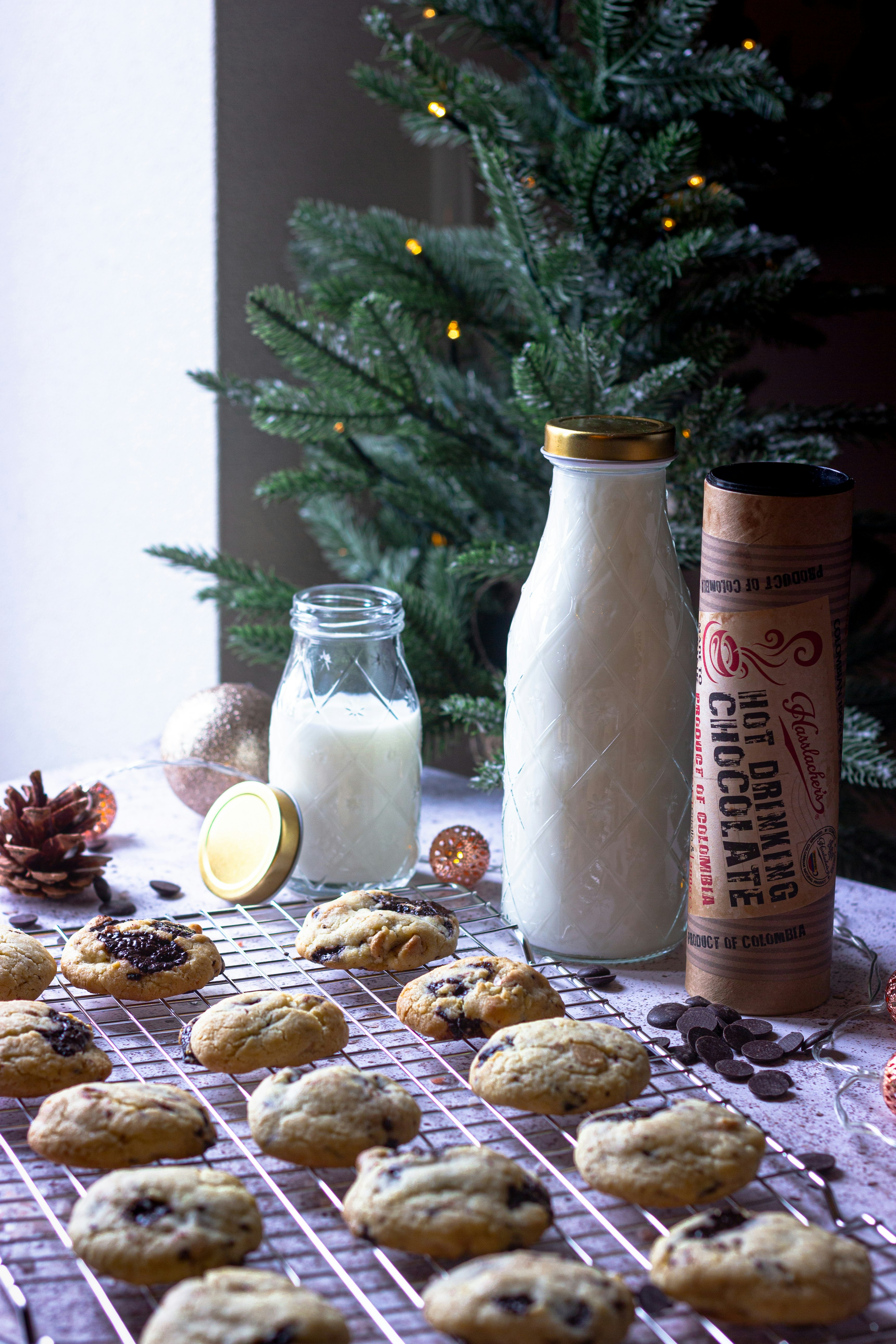 milk in clear glass jar beside cookies and cookies